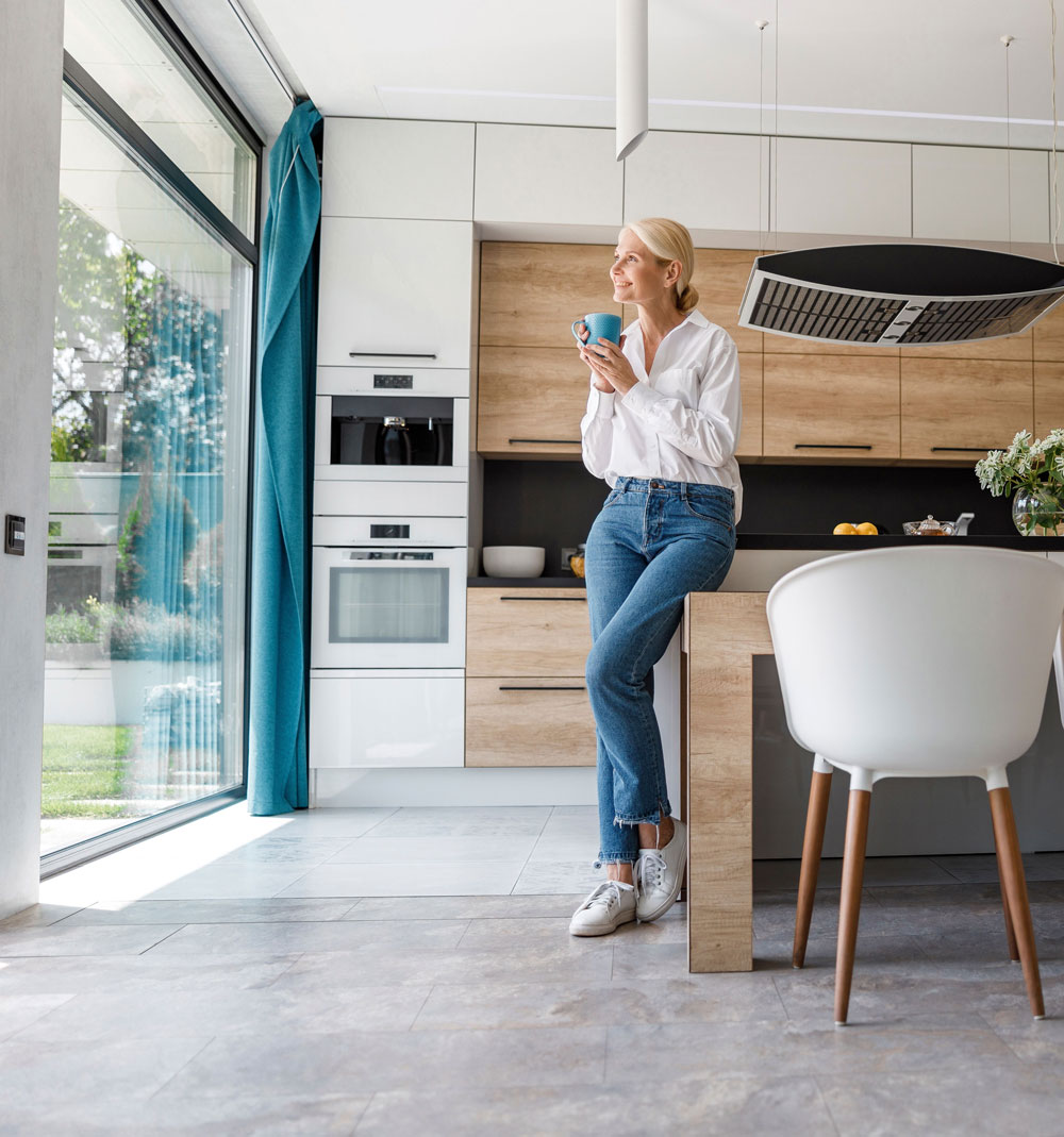 woman drinking coffee in kitchen
